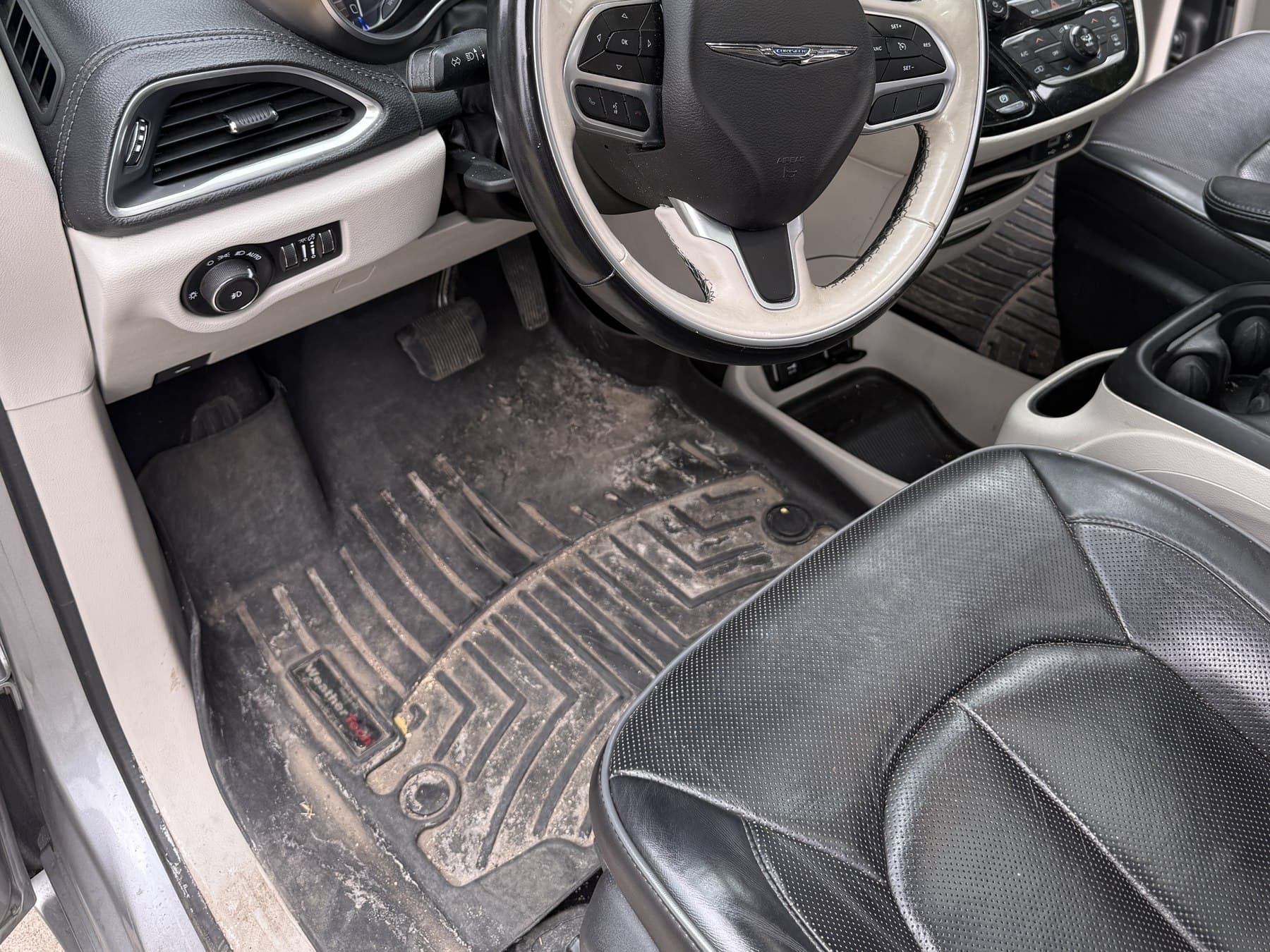 Van interior before mobile detailing, with a soiled floor mat